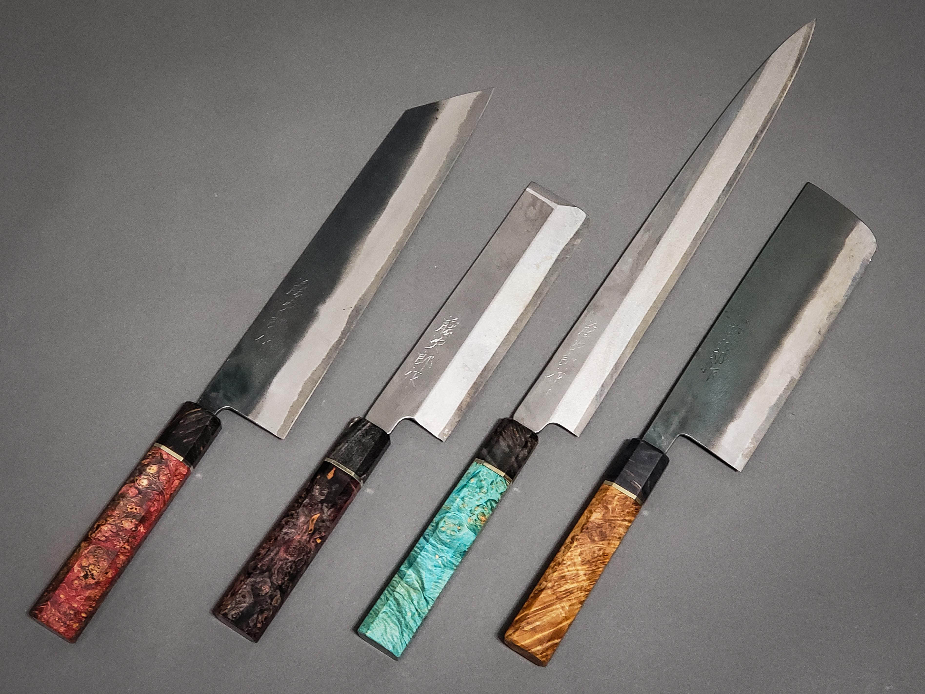 Four Japanese kitchen knives with decorative handles